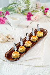 Grilled button mushrooms on a simple background