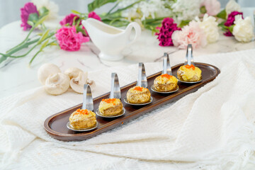 Grilled button mushrooms on a simple background