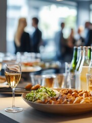 Business event in an office with a crowd of employees Food and drink in a meeting or conference room with business people in the background Blurred shot of business people at a party in the office