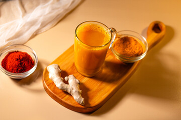 Immunity drink with turmeric powder. Turmeric tea. Trendy healthy drink with curcuma spices. Herbal...