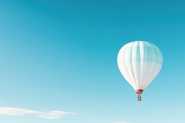 Naklejka premium lone hot air balloon floats gracefully in expansive blue sky surrounded by only vastness above providing ample copy