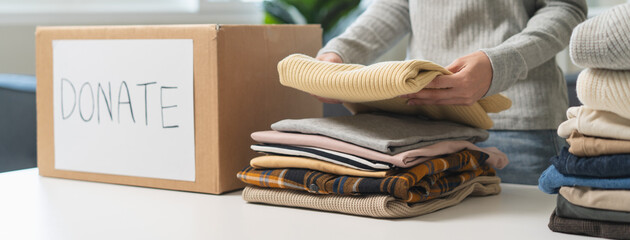 Organize closet and storage concept, people prepare unwanted old fashion clothes for share donation.