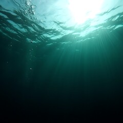 Obraz premium Sunlight filtering in ocean, deep blue background