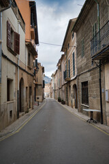 A narrow street with a few buildings in alaro majorca spain