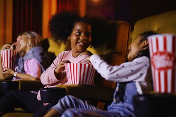 Young people watching movie in cinema
