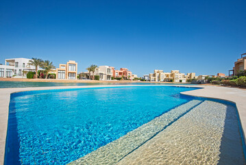 Outdoor swimming pool in a luxury tropical apartment resort