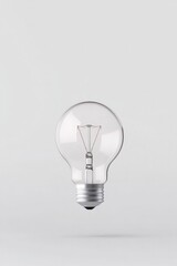 solitary light bulb appears suspended against vast empty white background casting subtle shadows and reflections inviting