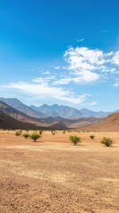 Obraz premium Serene Landscape of Arid Desert with Mountains and Clear Blue Sky