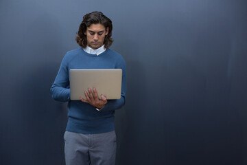 Business professional using laptop, concentrating on work in office environment, copy space