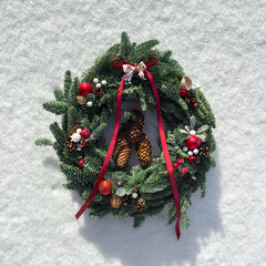 Wianek świąteczny na śniegu, Boże Narodzenie, kartka świąteczna, czerwone ozdoby bożonarodzeniowe. Christmas decorations.
