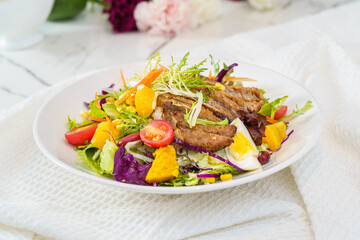 Mixed fruit and vegetable salad on a simple background