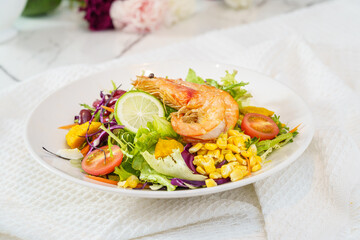 Mixed fruit and vegetable salad on a simple background