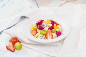 Mixed fruit and vegetable salad on a simple background