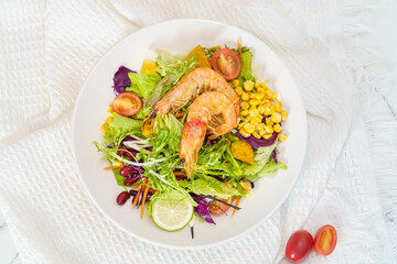 Mixed fruit and vegetable salad on a simple background
