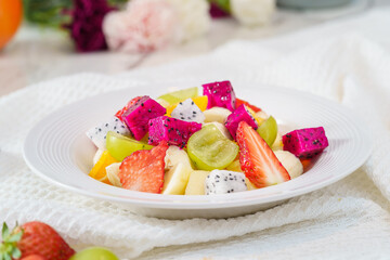 Mixed fruit and vegetable salad on a simple background