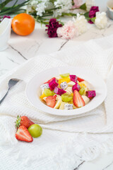 Mixed fruit and vegetable salad on a simple background