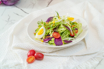 Mixed fruit and vegetable salad on a simple background