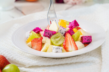 Mixed fruit and vegetable salad on a simple background