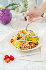Mixed fruit and vegetable salad on a simple background