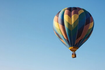 Fototapeta premium vibrant hot air balloon floats gracefully against clear blue sky backdrop offering ample copy space for text placement