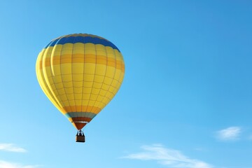Fototapeta premium vibrant hot air balloon floats gracefully against clear blue sky backdrop offering ample copy space for text placement
