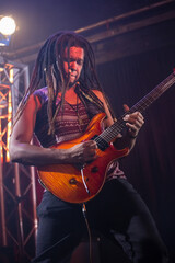 Obraz premium Playing electric guitar on stage, musician performing passionately at live concert