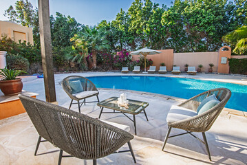 Patio terrace garden with chairs in tropical luxury villa with pool