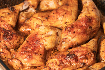 A plate of chicken is covered in spices and looks delicious
