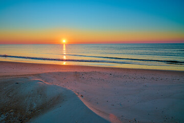 Sunrise over the Gulf of America at St. George Island Florida.