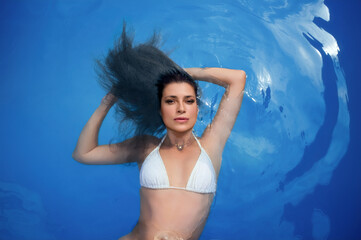 Woman relaxing in water wearing swimwear, enjoying peaceful aquatic atmosphere