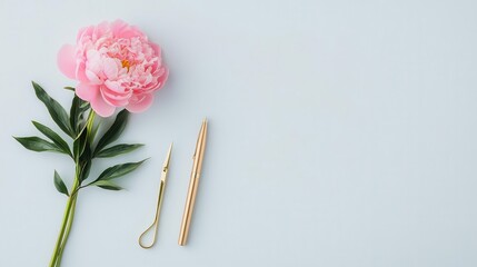 Soft blush peony next to a pair of sleek scissors and a gold pen, minimal and refined, isolated on a clean backdrop