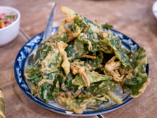 Crispy fried greens delight local market food urban setting close-up culinary experience
