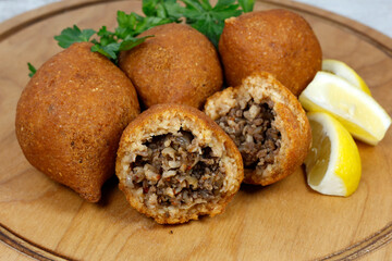 İçli köfte ( Turkish food içli köfte ) on wooden with lemon