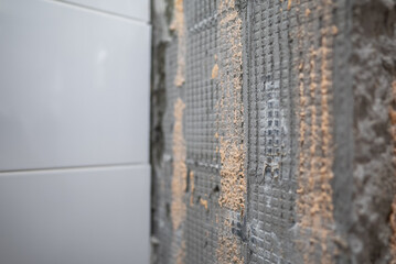 Partial tiling on one wall during renovation.