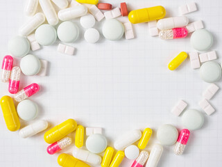 Pills of different shapes and colors on a spectacular background: an illustration of...