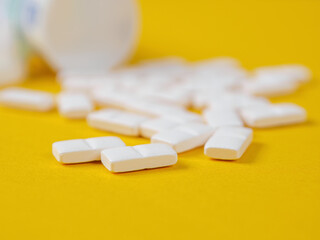 Pills of different shapes and colors on a spectacular background: an illustration of...