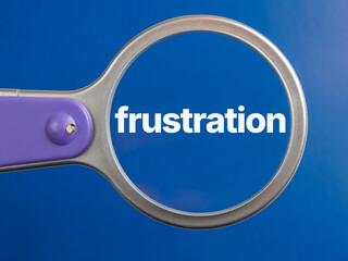 frustration text through magnifying glass blue background