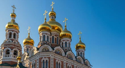 Fototapeta premium Golden Domes of an Orthodox Church, traditional architectural style, against a clear blue sky