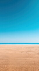 Fototapeta premium Serene Beach Scene with Clear Blue Sky and Tranquil Ocean View