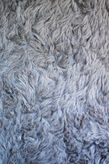 This is a detailed closeup image showcasing the texture of a gray fur rug