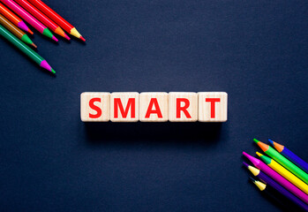 Smart symbol. Concept word Smart on beautiful wooden blocks. Beautiful black table black background. Beautiful colored pencils. Business lifestyle smart concept. Copy space.