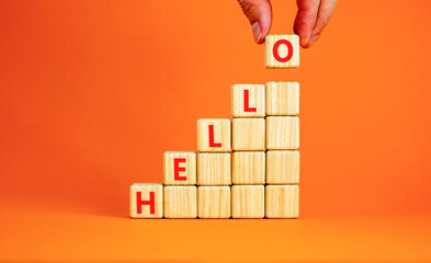 Hello symbol. Concept word Hello on beautiful wooden blocks. Beautiful orange table orange...