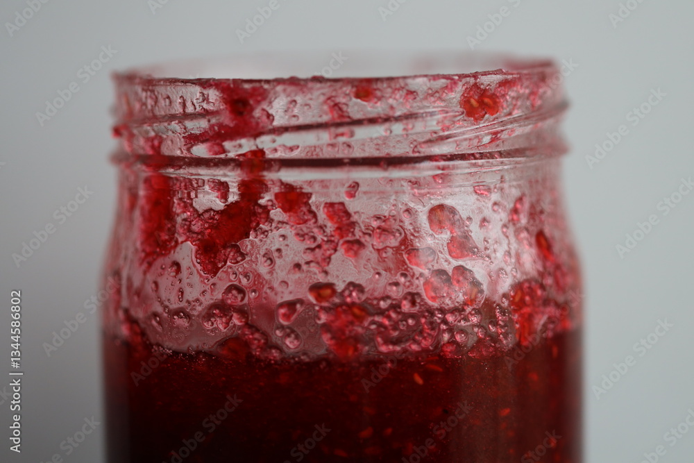 Poster a jar of jam is placed on a table.