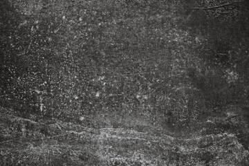 Black and white photo of an old brick wall with texture and cracks.