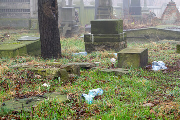 Greek Orthodox cemetery. Abandoned, overgrown, ruined cemetery in the fog. Crumbling tombstones, gravestones without names or surnames. Resting place of the dead
