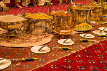 View of golden banquet table setting for for guests in Dubai.