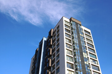Gazing upward at three towering buildings set against a clear blue sky
