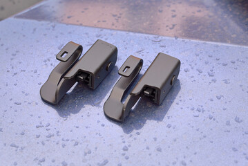 Wiper blade adapter, offset hook mount. Offset hook adapter on wet metallic surface. Wiper blade...
