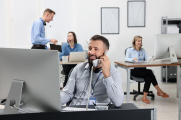 Technical support call center. Team of operators working in office