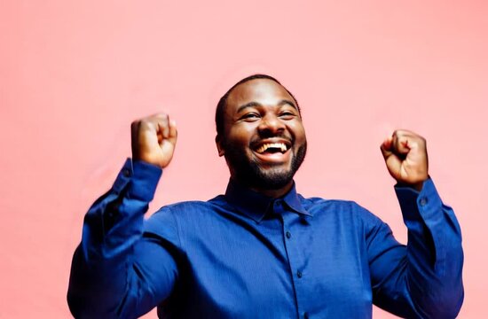 Happy plus size businessman man with arms up, feeling great and smiling at the camera.